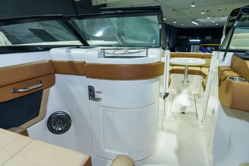 Slide: The Image of 2015 Sea Ray 270 Sundeck interior with tan seating and table, showcasing luxury design. - 20