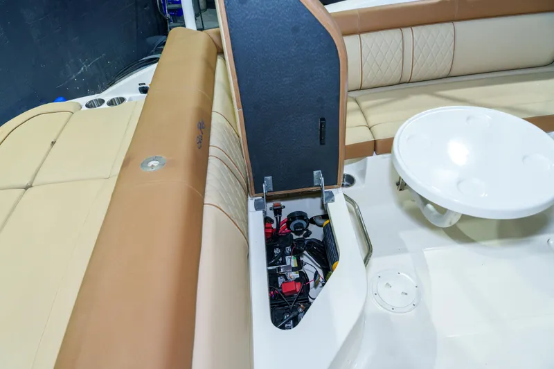 Slide: The Image of 2015 Sea Ray 270 Sundeck interior with open storage compartment and seating area. - 26