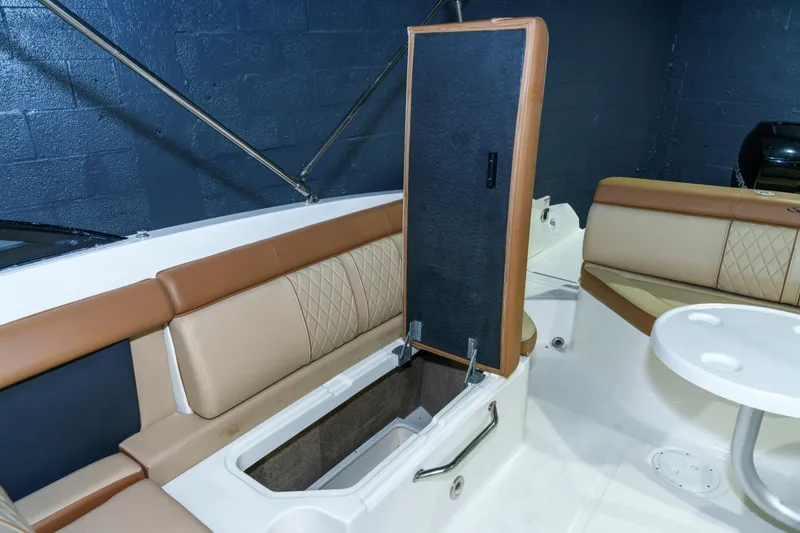 Slide: The Image of 2015 Sea Ray 270 Sundeck interior with open storage compartment and seating. - 27