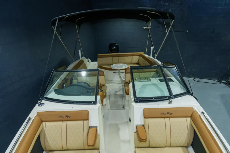 Slide: The Image of 2015 Sea Ray 270 Sundeck boat with tan leather seating and black canopy. - 3