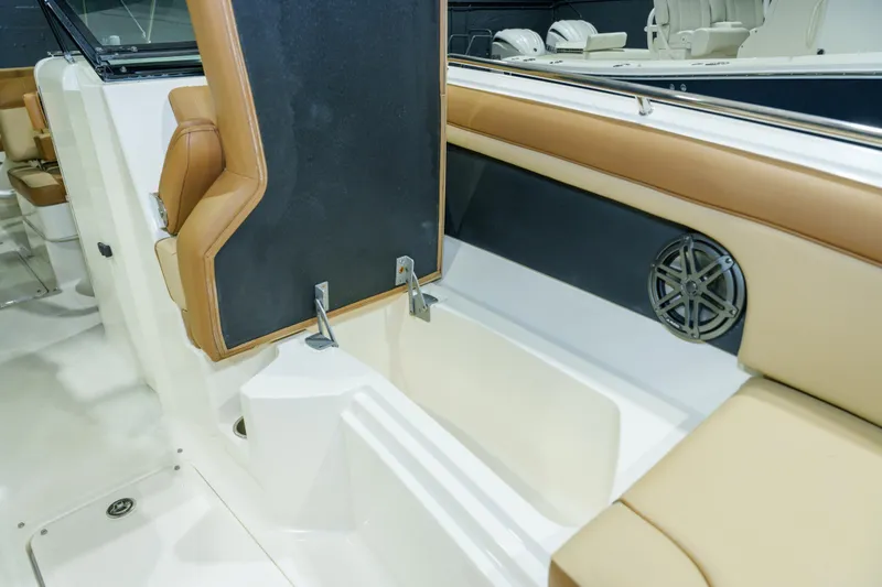 Slide: The Image of 2015 Sea Ray 270 Sundeck interior with tan seating and speaker detail. - 32