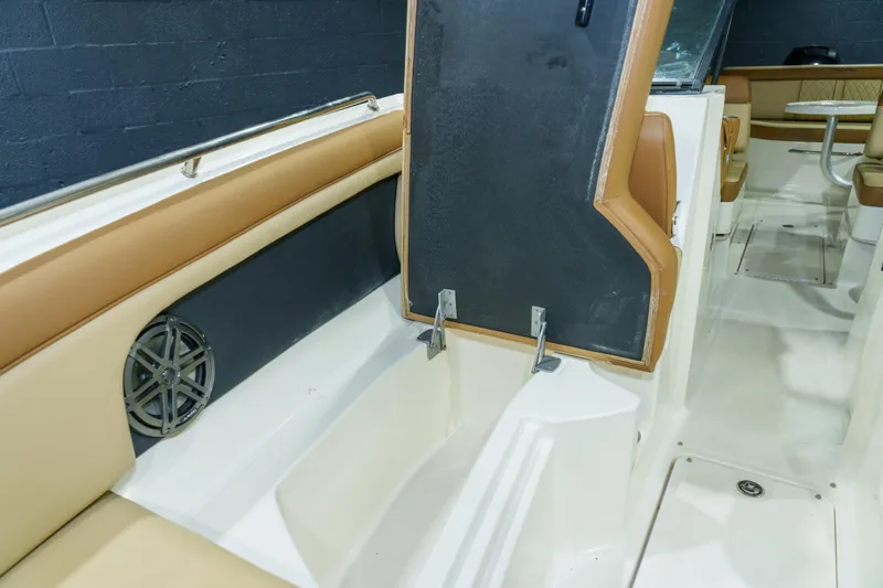 Slide: The Image of 2015 Sea Ray 270 Sundeck interior with tan seating and speaker detail. - 33