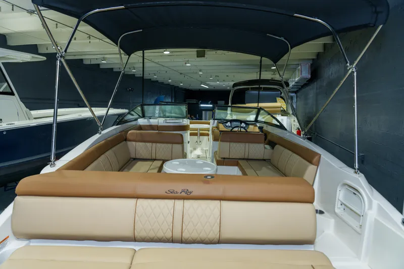 Slide: The Image of 2015 Sea Ray 270 Sundeck boat interior with tan seating and canopy. - 34