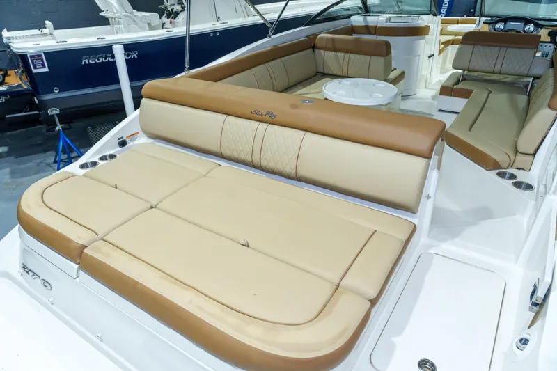 Slide: The Image of 2015 Sea Ray 270 Sundeck interior with tan leather seating and cup holders. - 36