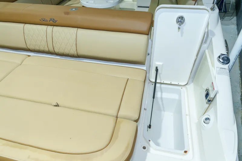 Slide: The Image of 2015 Sea Ray 270 Sundeck interior with tan seating and storage compartment. - 37