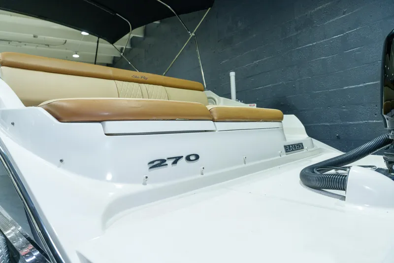 Slide: The Image of 2015 Sea Ray 270 Sundeck boat with tan seating and sleek design. - 38