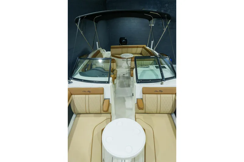 Slide: The Image of 2015 Sea Ray 270 Sundeck interior with tan seating and black canopy. - 4