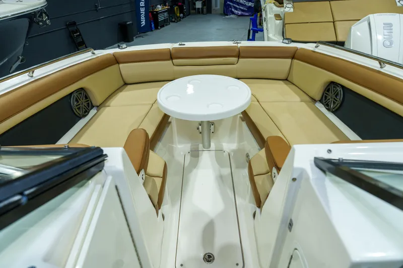 Slide: The Image of 2015 Sea Ray 270 Sundeck interior with tan seating and round table. - 5