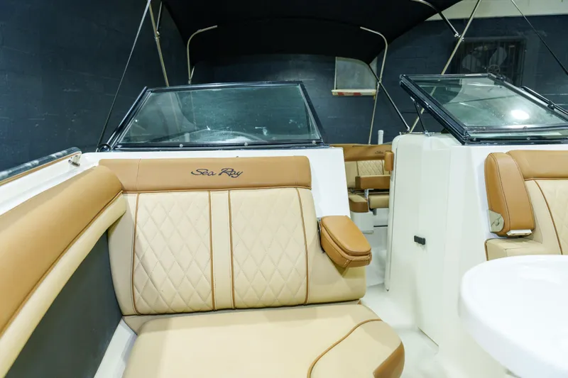 Slide: The Image of 2015 Sea Ray 270 Sundeck interior with tan leather seating and black canopy. - 7