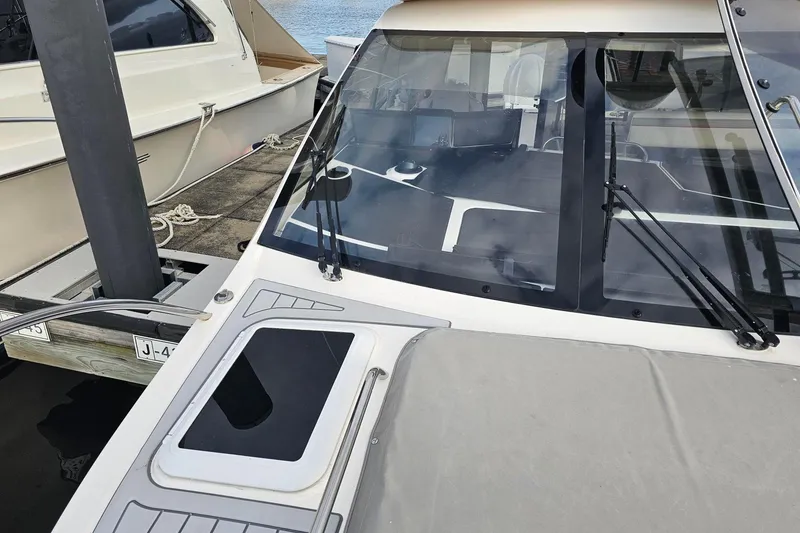 Slide: The Image of 2026 Solara S-310 SB boat docked, showcasing sleek design and modern features. - 12