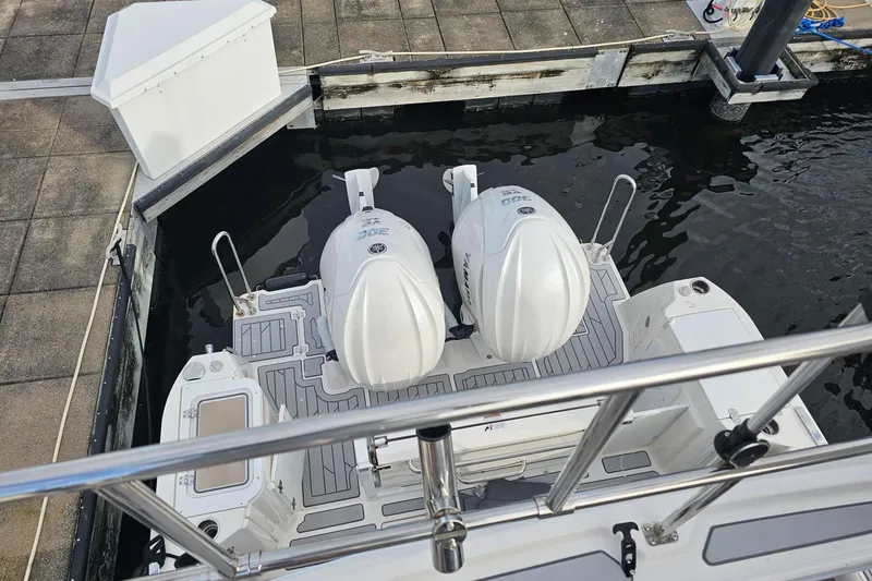 Slide: The Image of 2026 Solara S-310 SB boat with dual outboard engines docked at marina. - 16