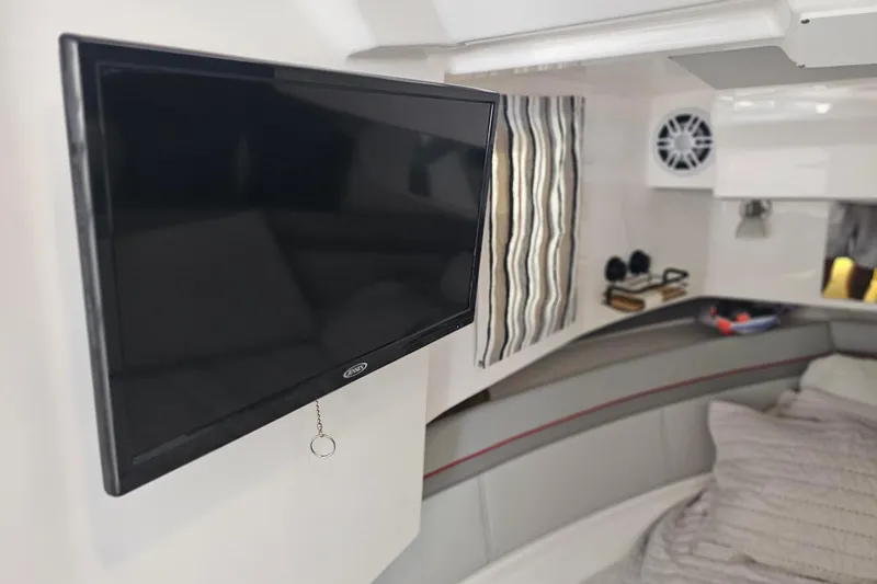 Slide: The Image of Interior of 2026 Solara S-310 SB boat with mounted TV and cozy seating area. - 23