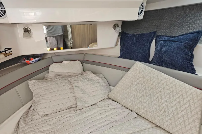 Slide: The Image of Cozy cabin interior of 2026 Solara S-310 SB with plush bedding and pillows. - 24