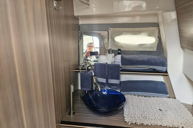 Slide: The Image of Modern bathroom in 2026 Solara S-310 SB yacht with blue sink and towels. - 25