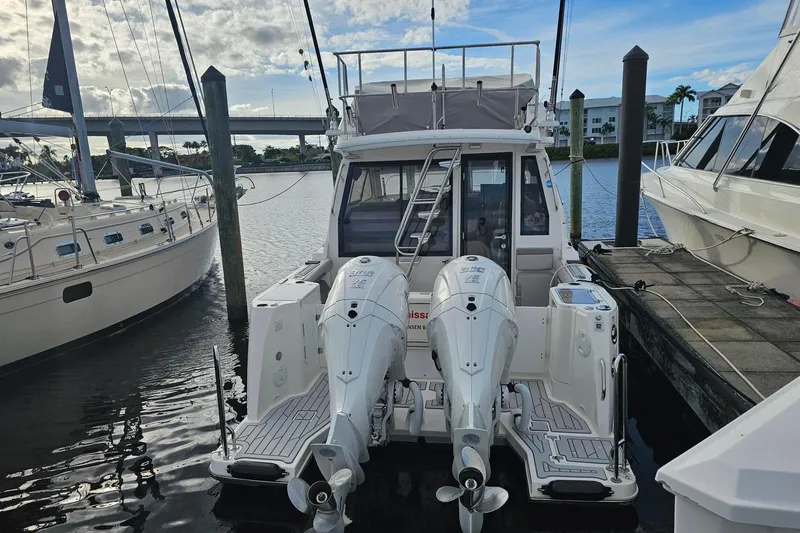 Slide: The Image of 2026 Solara S-310 SB boat docked with dual outboard engines. - 3