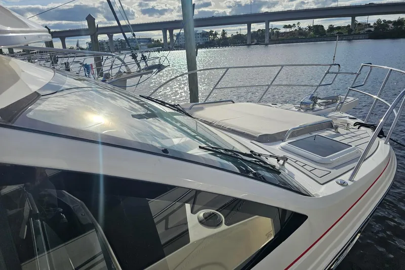 Slide: The Image of 2026 Solara S-310 SB yacht docked by a scenic waterfront bridge. - 4