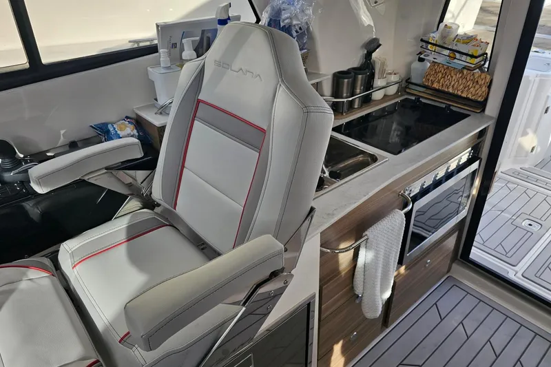 Slide: The Image of Interior of 2026 Solara S-310 SB boat with modern kitchen and seating. - 6