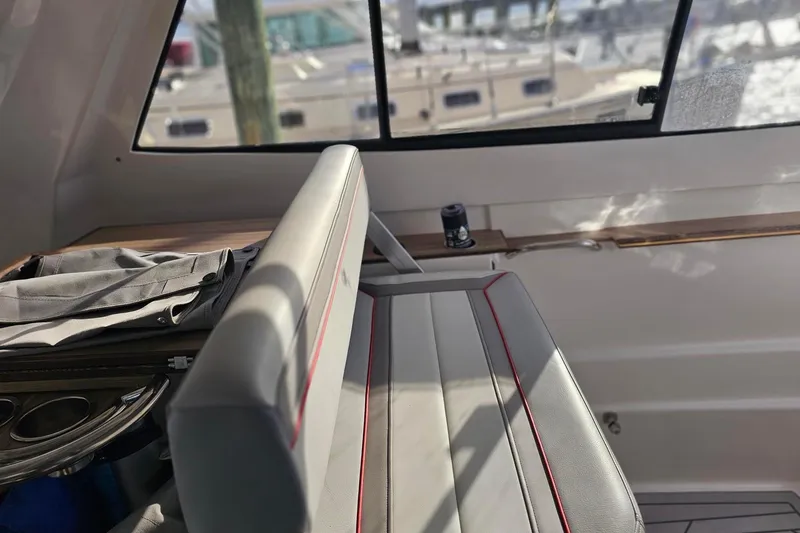 Slide: The Image of Interior of 2026 Solara S-310 SB boat with sleek seating and window view. - 8