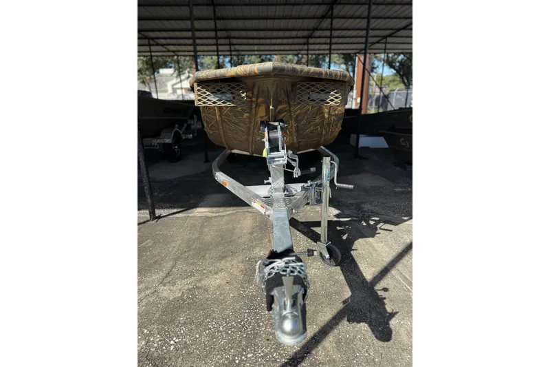 Slide: The Image of 2026 G3 Gator Tough 16 DK boat on trailer, under covered storage. - 1