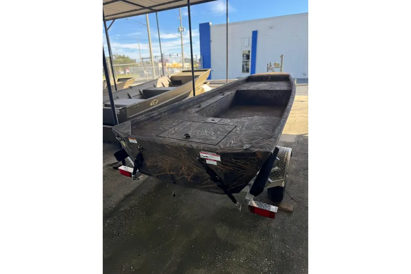 Slide: The Image of 2026 G3 Gator Tough 16 DK boat on trailer, camo design, outdoor display. - 2