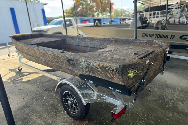 Slide: The Image of 2026 G3 Gator Tough 16 DK boat on trailer, camo design, outdoor display. - 3