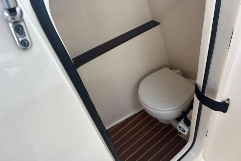 Slide: The Image of 2017 Scout 255 Dorado boat interior with compact marine toilet. - 10