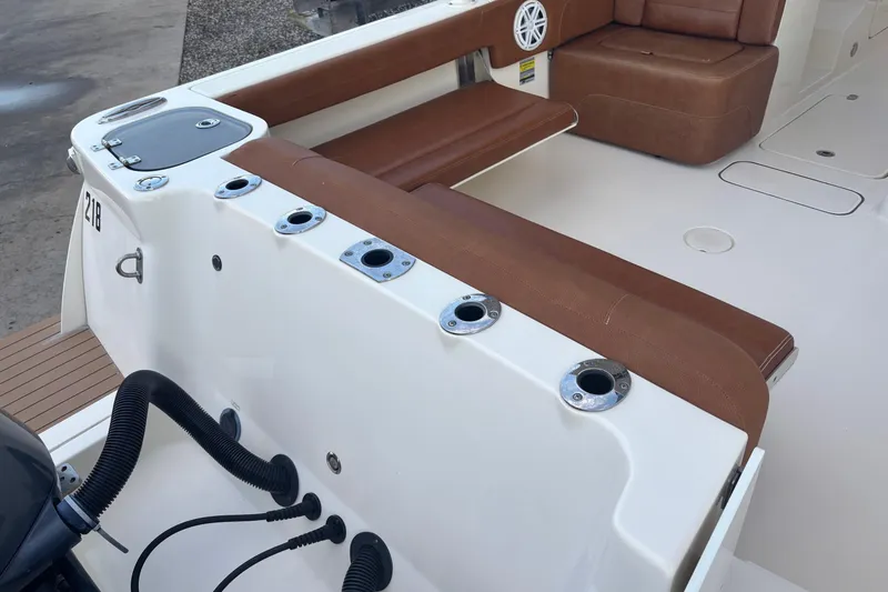 Slide: The Image of 2017 Scout 255 Dorado boat interior with brown seating and rod holders. - 13