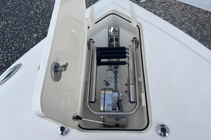 Slide: The Image of Anchor storage compartment on a 2017 Scout 255 Dorado boat, featuring stainless steel fittings. - 22