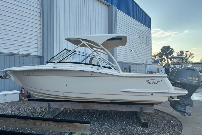 Slide: The Image of 2017 Scout 255 Dorado boat with Yamaha engine, docked outdoors. - 3