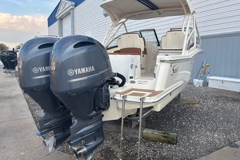 Slide: The Image of 2017 Scout 255 Dorado boat with twin Yamaha 150 engines, docked outdoors. - 9