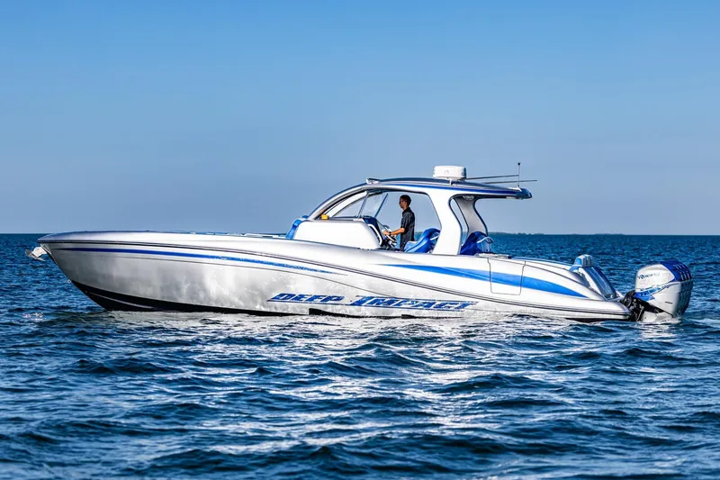 The Image of 2019 Deep Impact 399 Sport boat cruising on open water under clear blue sky. - 0
