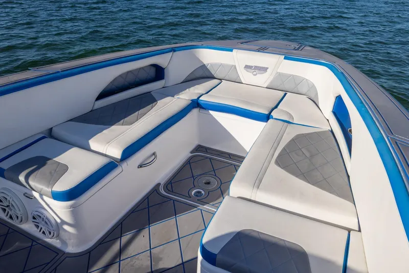Slide: The Image of 2019 Deep Impact 399 Sport boat interior with blue and white cushioned seating. - 10