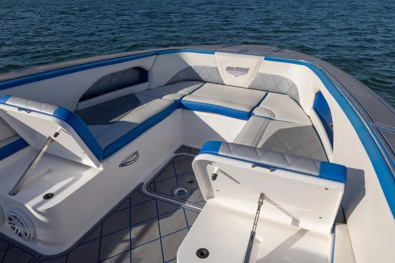 Slide: The Image of 2019 Deep Impact 399 Sport boat interior with blue and gray seating on water. - 11