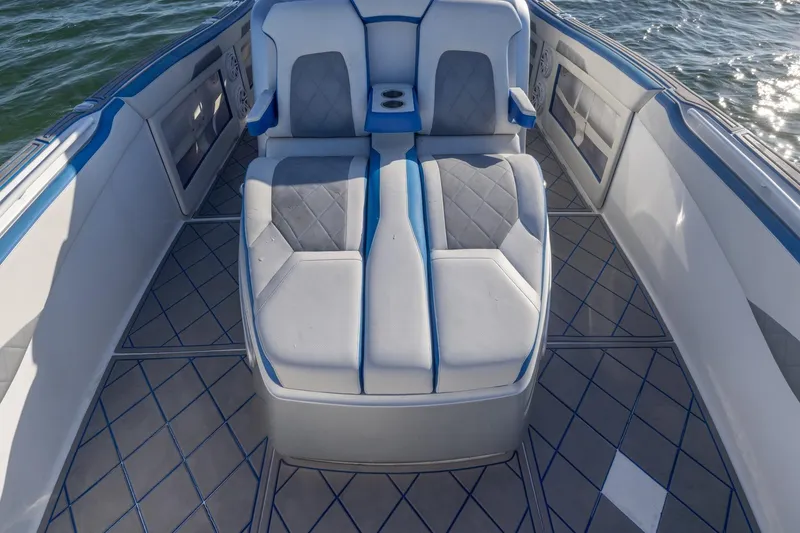 Slide: The Image of 2019 Deep Impact 399 Sport boat interior with cushioned seating and blue accents. - 13