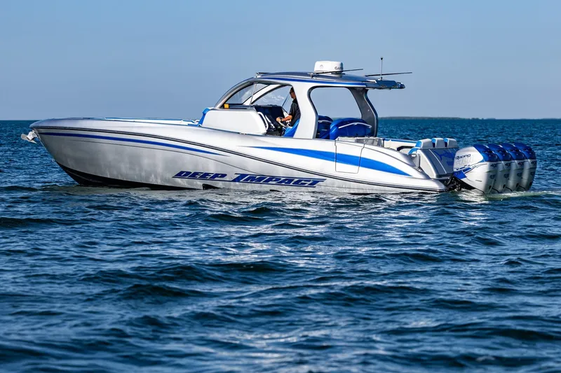 Slide: The Image of 2019 Deep Impact 399 Sport boat cruising on open water, featuring sleek design and powerful engines. - 2