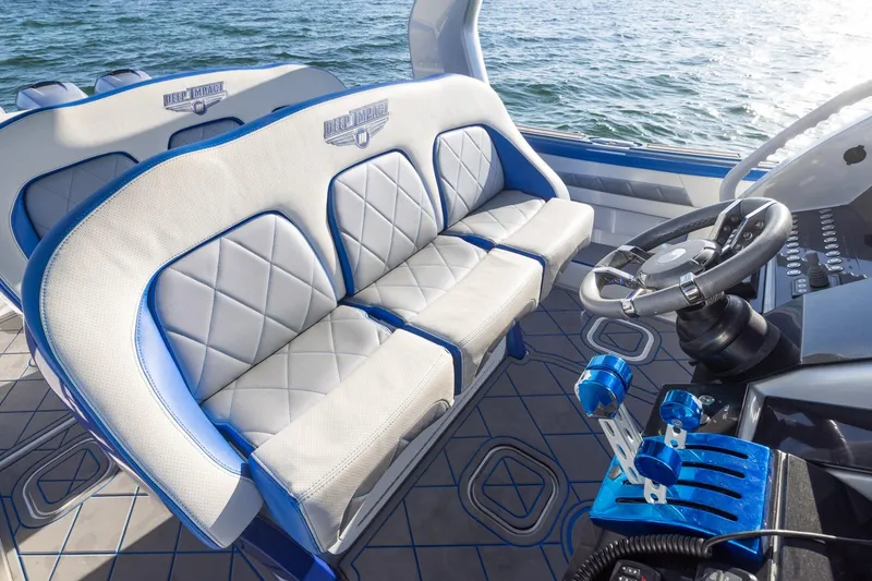 Slide: The Image of Interior of 2019 Deep Impact 399 Sport boat with luxury seating and steering wheel. - 23