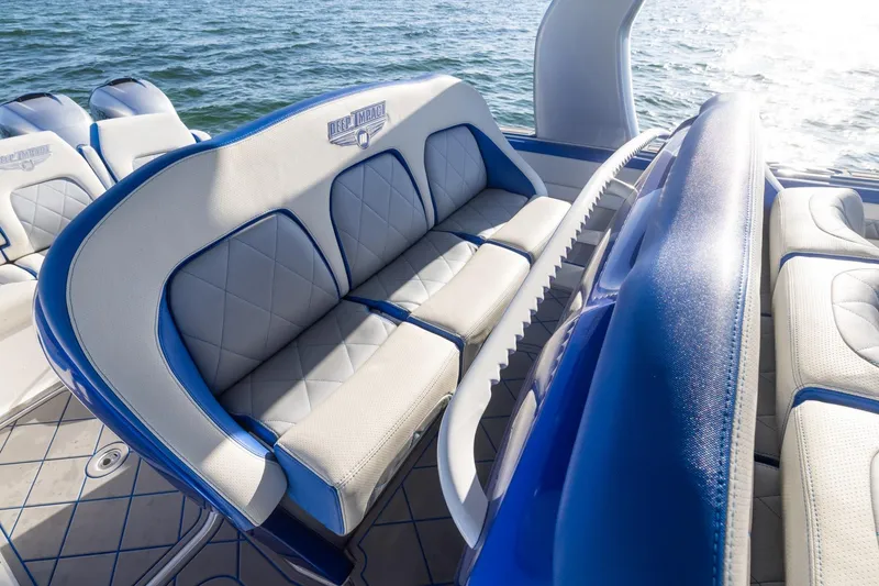 Slide: The Image of Luxurious seating on 2019 Deep Impact 399 Sport boat, featuring blue and white upholstery. - 24