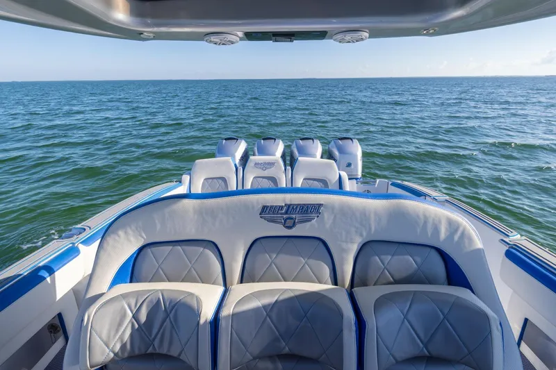 Slide: The Image of 2019 Deep Impact 399 Sport boat interior with ocean view, featuring luxurious seating. - 26