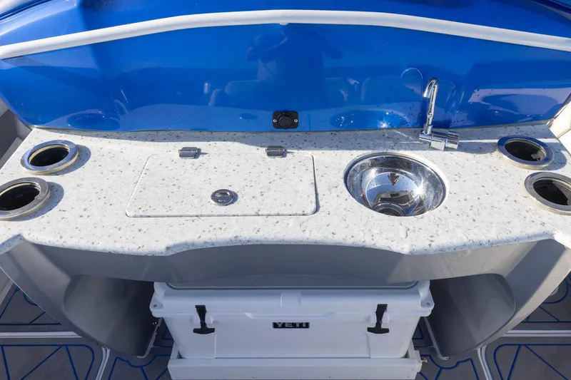 Slide: The Image of 2019 Deep Impact 399 Sport boat kitchenette with sink, countertop, and cup holders. - 28