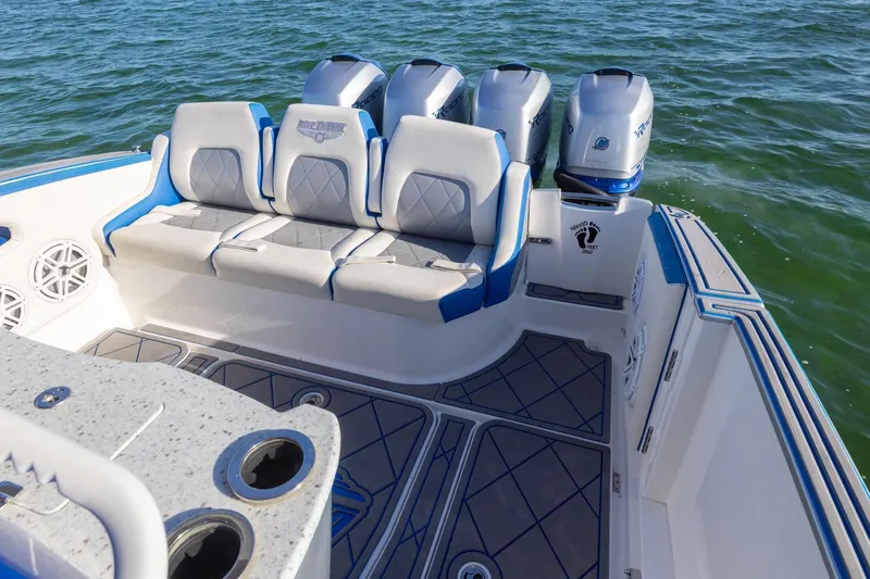 Slide: The Image of 2019 Deep Impact 399 Sport boat with cushioned seating and powerful outboard engines. - 32