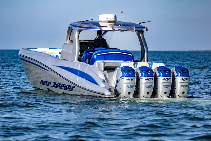 Slide: The Image of 2019 Deep Impact 399 Sport boat with four powerful engines cruising on the water. - 4