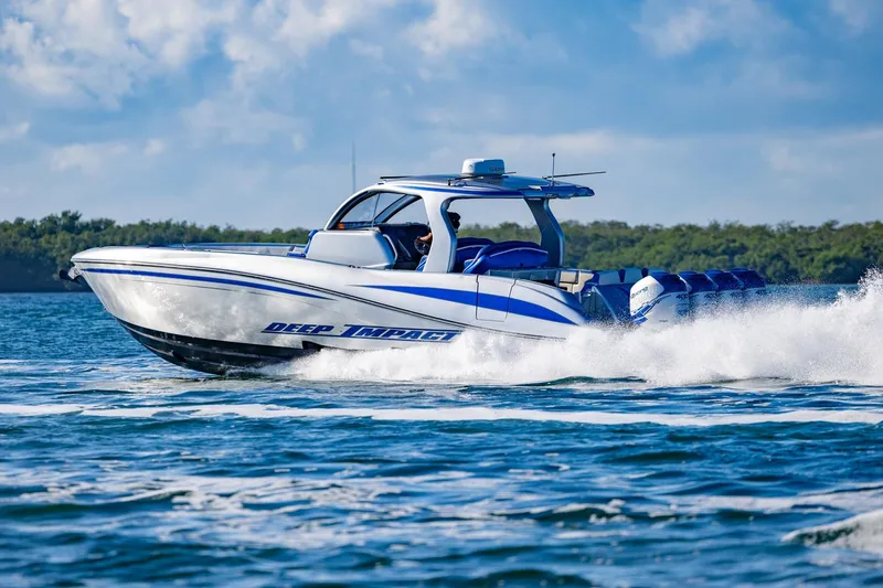 Slide: The Image of 2019 Deep Impact 399 Sport boat cruising on open water, showcasing speed and performance. - 45