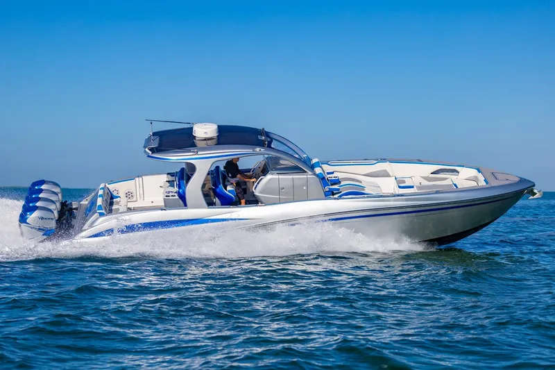 Slide: The Image of 2019 Deep Impact 399 Sport boat cruising on open water, showcasing sleek design and powerful engines. - 47