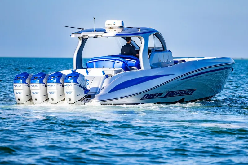 Slide: The Image of 2019 Deep Impact 399 Sport boat cruising with four powerful engines. - 6