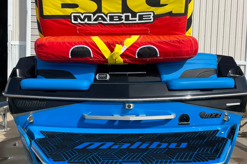 Slide: The Image of 2019 Malibu Wakesetter 24 MXZ with Big Mable inflatable, blue and black design. - 10