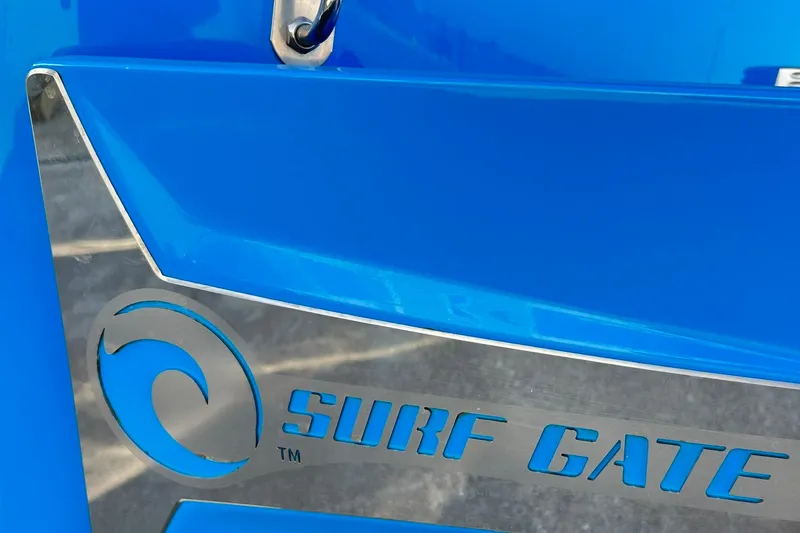 Slide: The Image of Close-up of 2019 Malibu Wakesetter 24 MXZ Surf Gate logo on blue surface. - 12