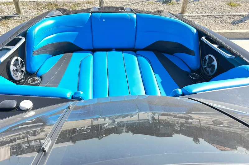 Slide: The Image of 2019 Malibu Wakesetter 24 MXZ with vibrant blue and black seating. - 16