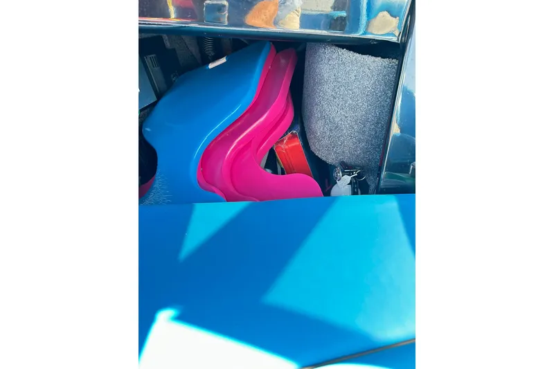 Slide: The Image of Storage compartment in a 2019 Malibu Wakesetter 24 MXZ with colorful life vests. - 17