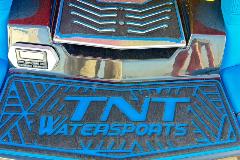 Slide: The Image of 2019 Malibu Wakesetter 24 MXZ with TNT Watersports branding on blue and black mat. - 19