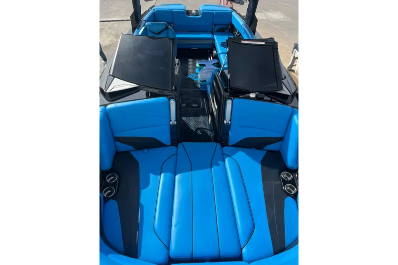 Slide: The Image of 2019 Malibu Wakesetter 24 MXZ interior with blue seating and cup holders. - 3